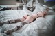 A woman laying on top of a bed in lingerie.