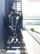 Two young women standing on the steps of a building.