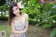 A woman in a floral dress posing for a picture.