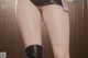 A close up of a woman's legs wearing black stockings and boots.