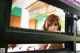 A woman looking out of a bunk bed in a room.